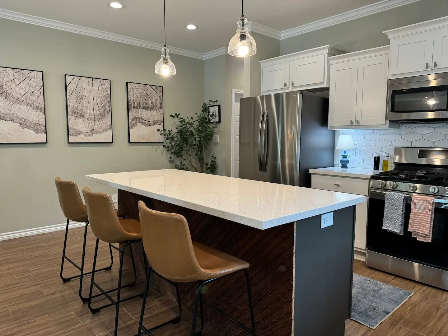Kitchen island with bar stools and stainless appliances