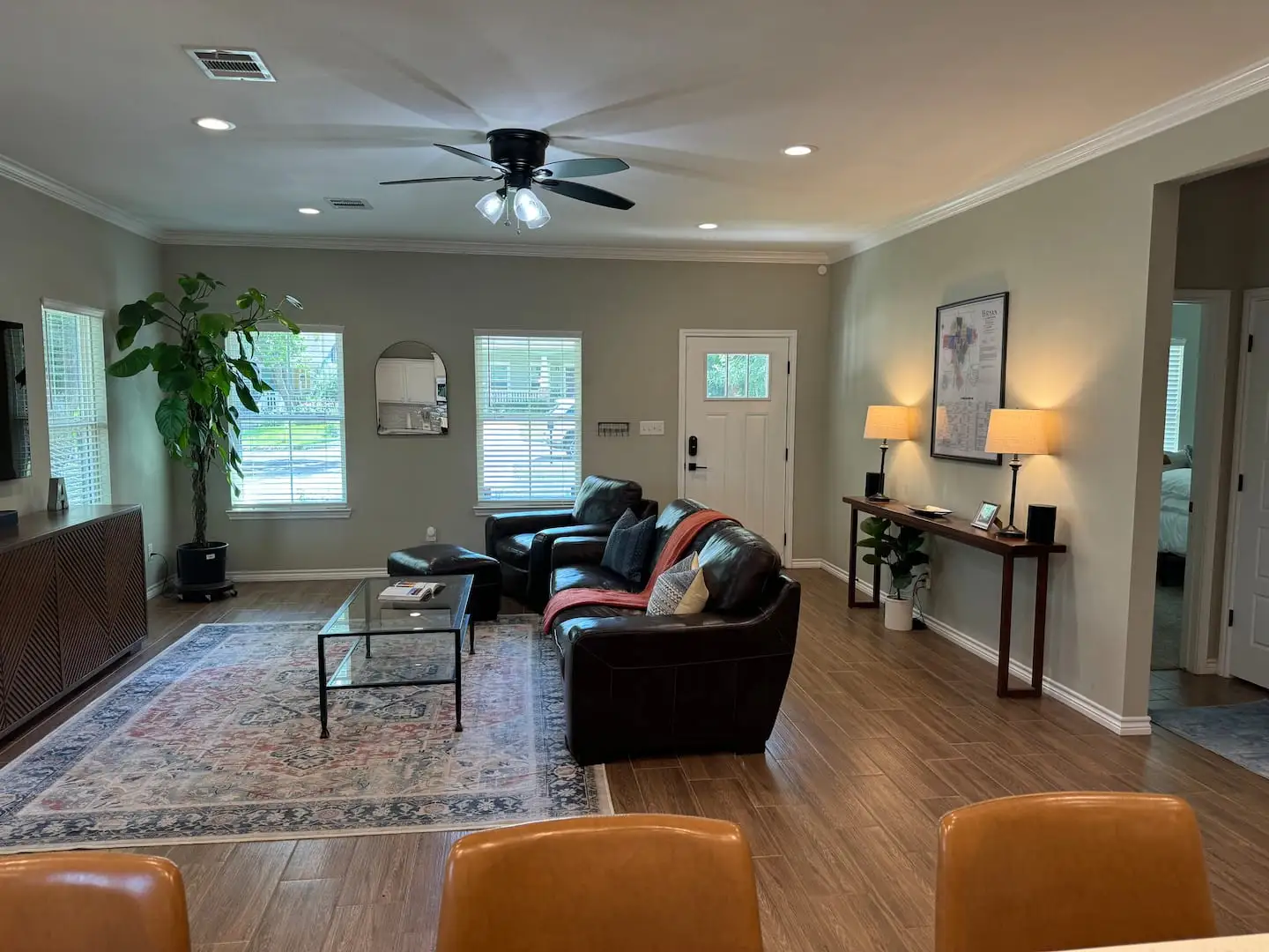 Living room with leather sofa and ceiling fan